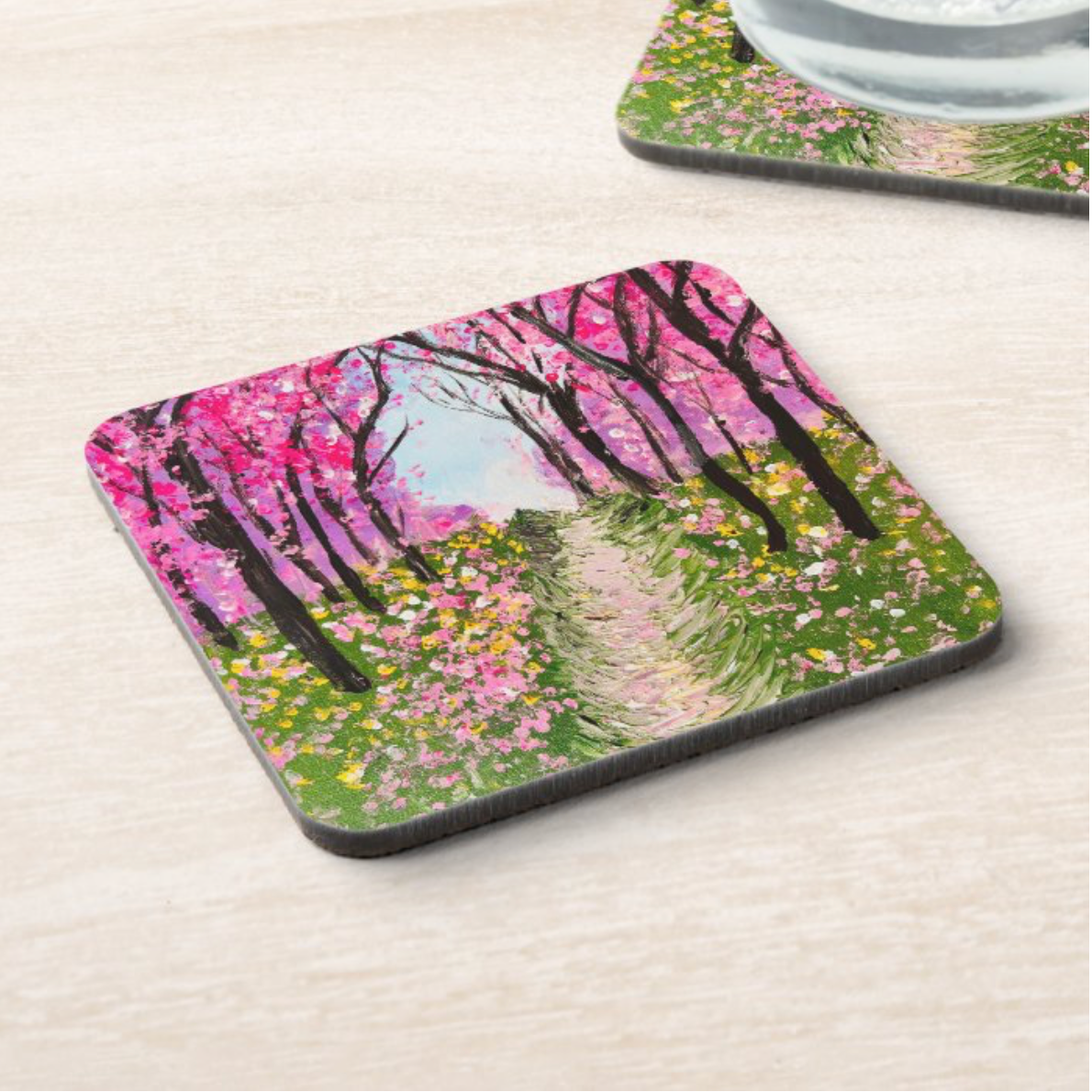 Glossy 9.5cm square hardboard coaster featuring a vibrant pink cherry tree walkway painting.
