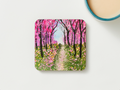 Square wooden coaster, front view, pink cherry blossom forest path painting design.