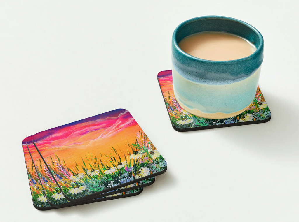 Glossy 9.5cm hardboard coaster featuring a vibrant floral field acrylic painting, shown with a ceramic mug on a white surface.