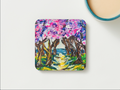 Square 9.5cm hardboard coaster with a glossy pink and purple textured acrylic tree path painting.