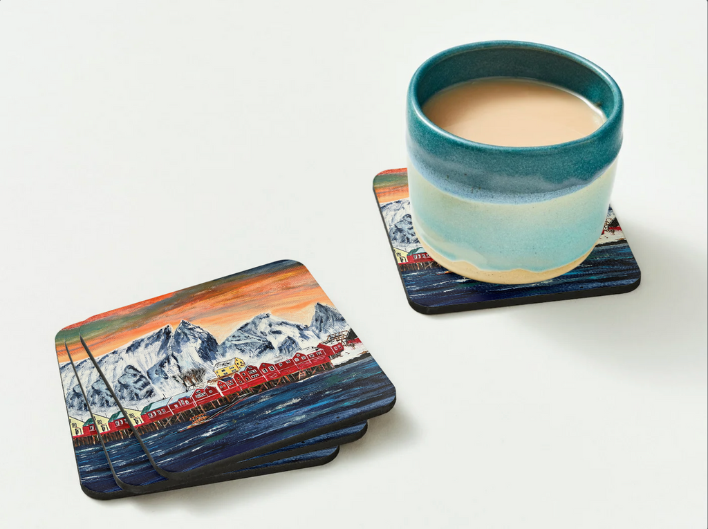 Glossy 9.5cm hardboard coaster featuring a vibrant fishing village painting, shown with a ceramic mug on a white background.