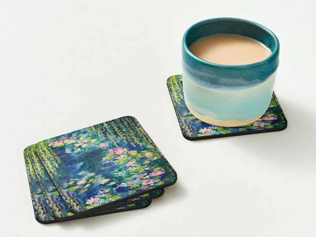 Glossy 9.5cm hardboard coasters featuring a vibrant Waterlily Pond acrylic painting, with a ceramic mug on one.