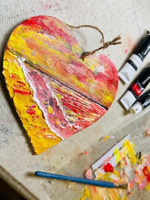 Hanging heart ornament with jute twine, textured yellow, pink and red abstract paint strokes.