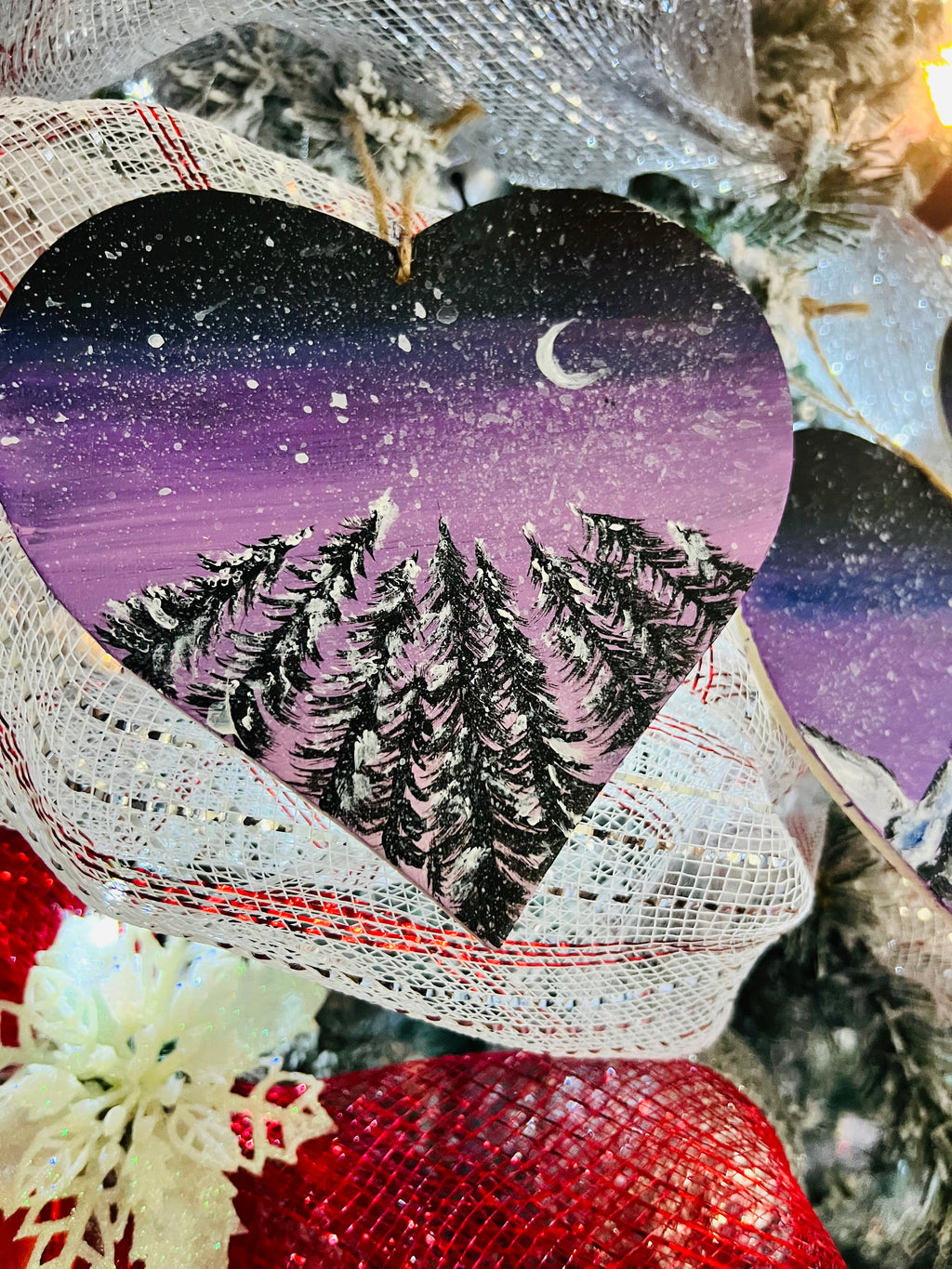 Hanging heart art decoration, purple starry sky with crescent moon, pine trees and mountain peaks