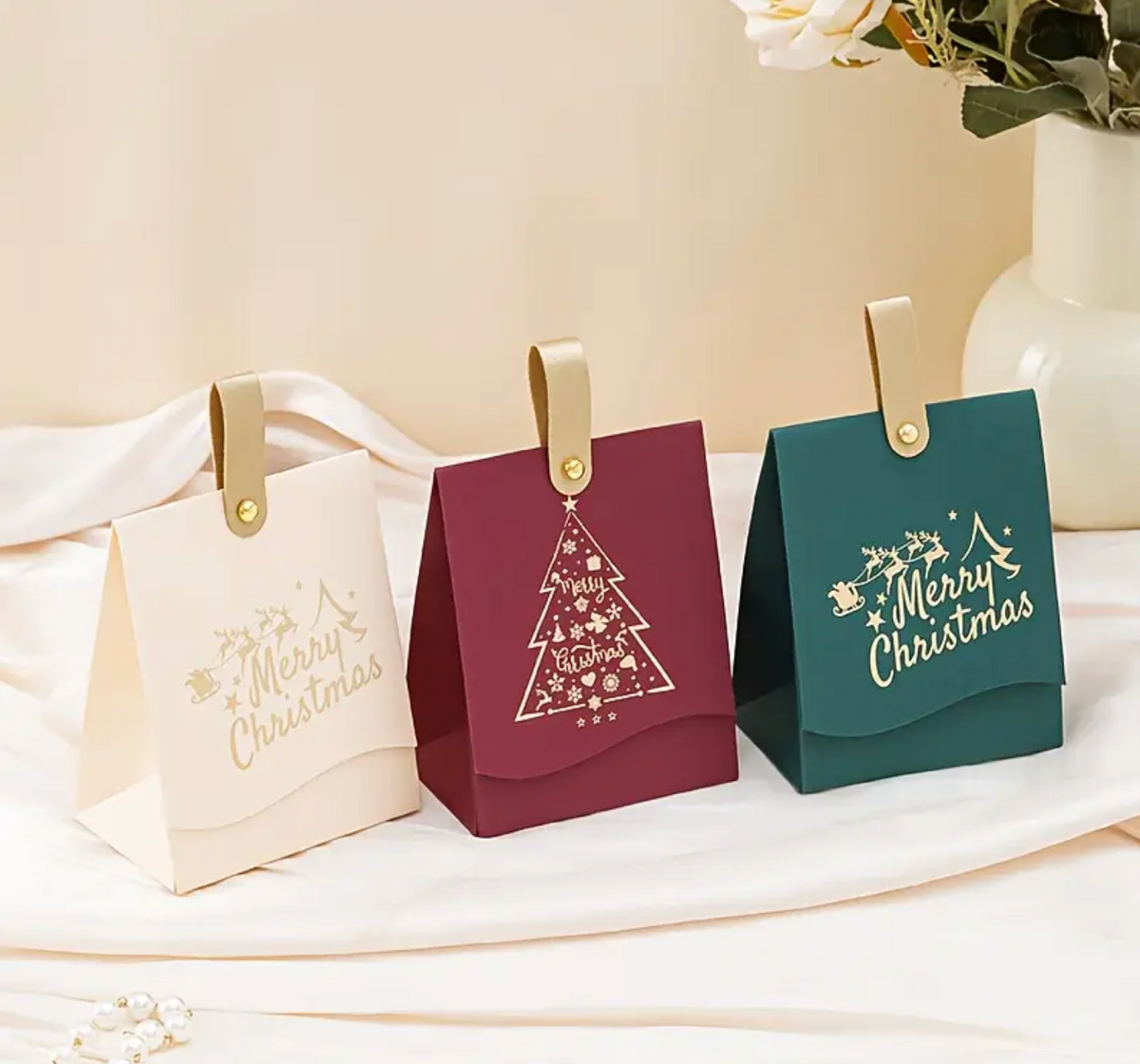 Merry Christmas gift bags with gold handle eyelets and festive tree designs