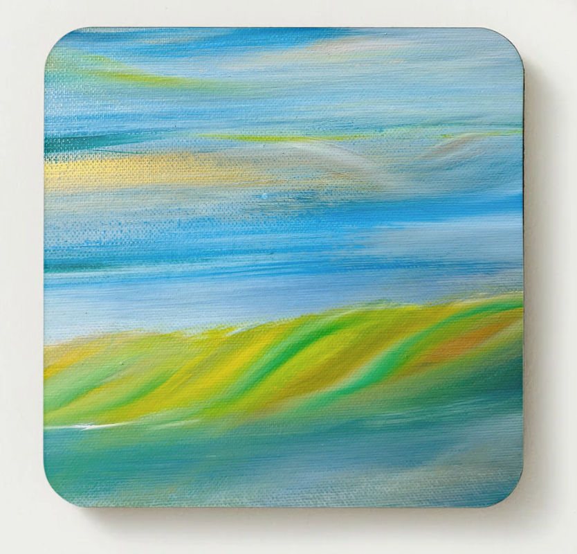 Hardboard coaster with bright blue sky and green hills artwork, square with rounded corners