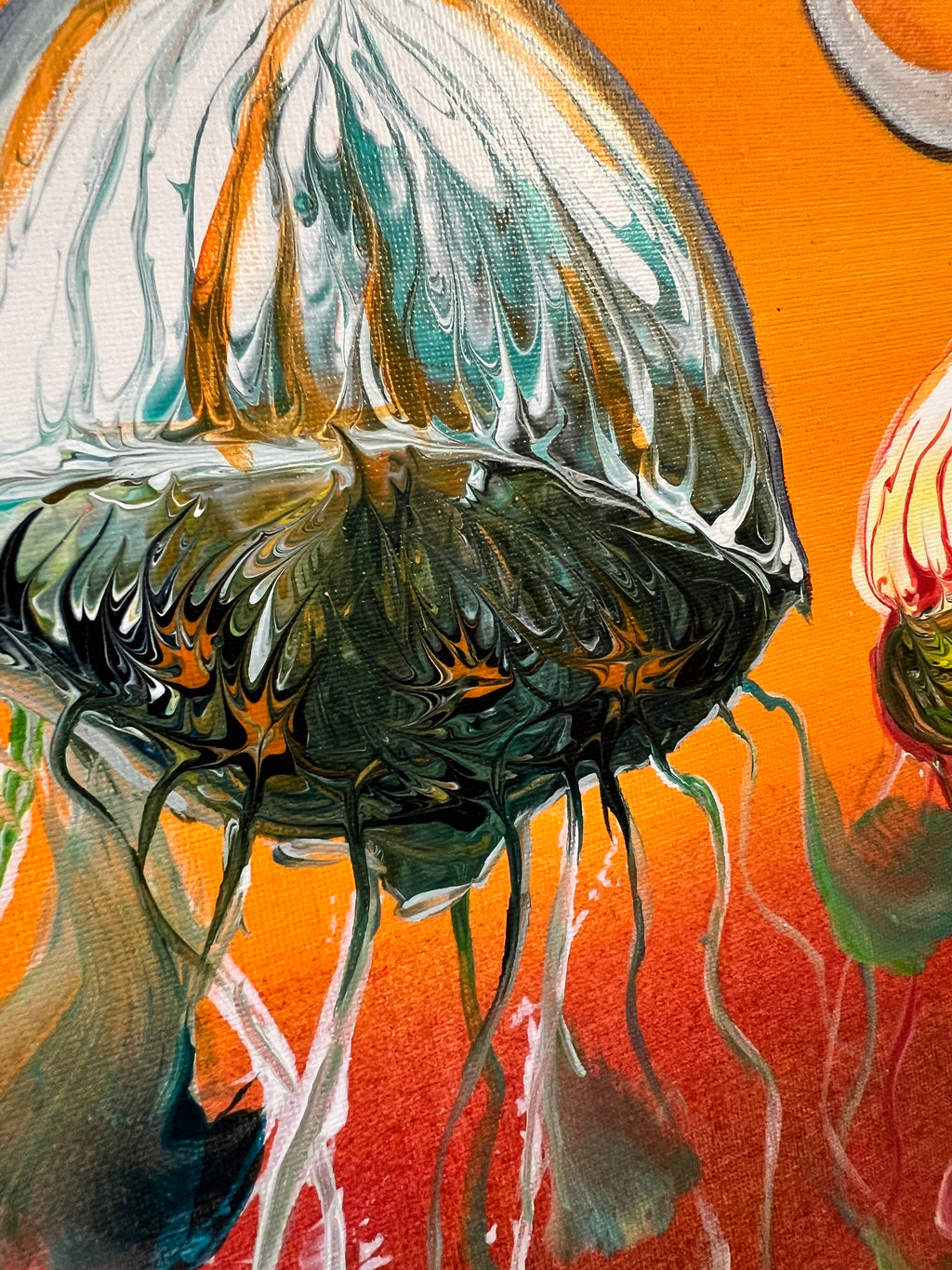 Close-up jellyfish wall art showing blue-green jellyfish with flowing tentacles