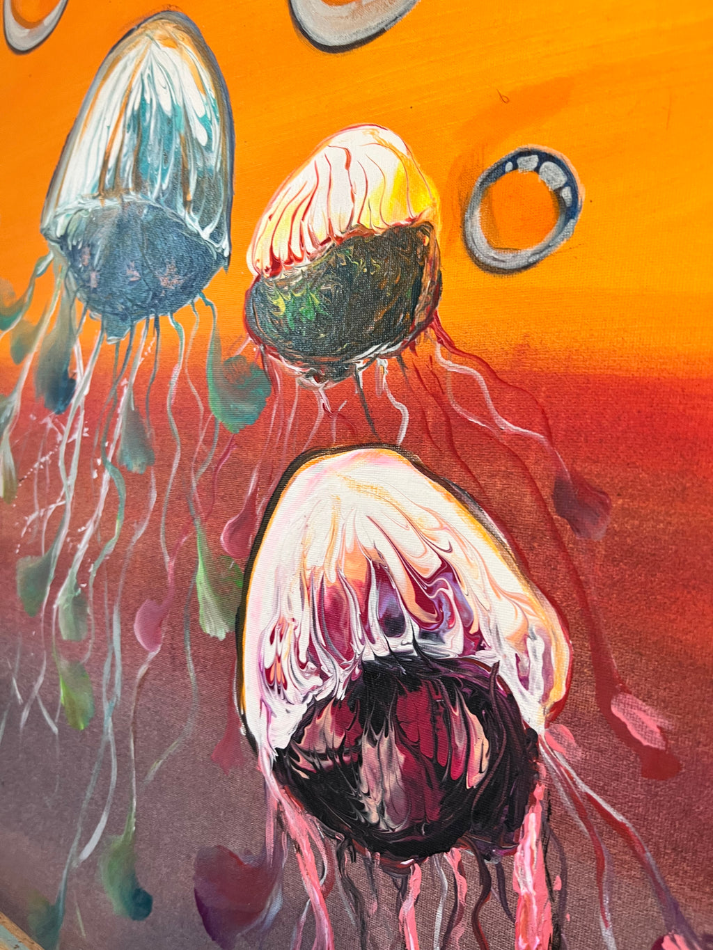 Jellyfish wall art showing three jellyfish and bubble rings on orange and purple