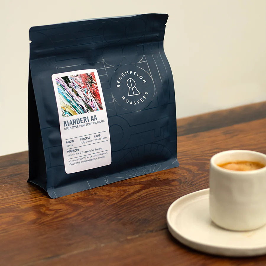 Dark blue coffee bean pouch with label and Redemption Roasters emblem