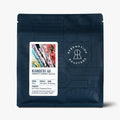 Dark blue coffee bean pouch, detailed front label with origin and grind info