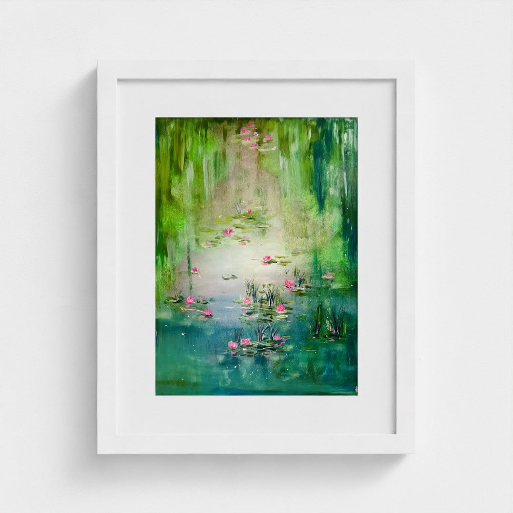 White framed art print with a green lily pond scene and pink flowers