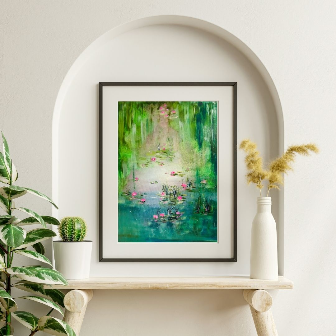 Framed abstract lagoon painting with pink water lilies on a shelf, dark gray frame