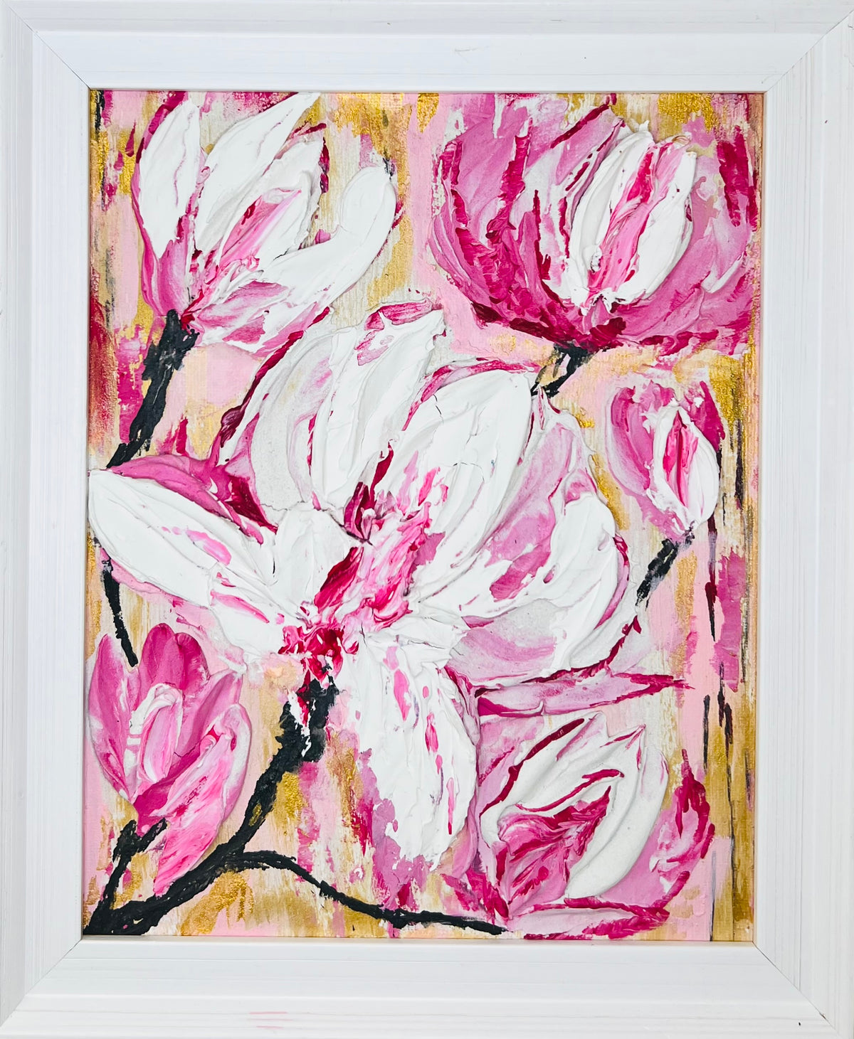 White-framed pink and white magnolia floral artwork with gold and yellow accents