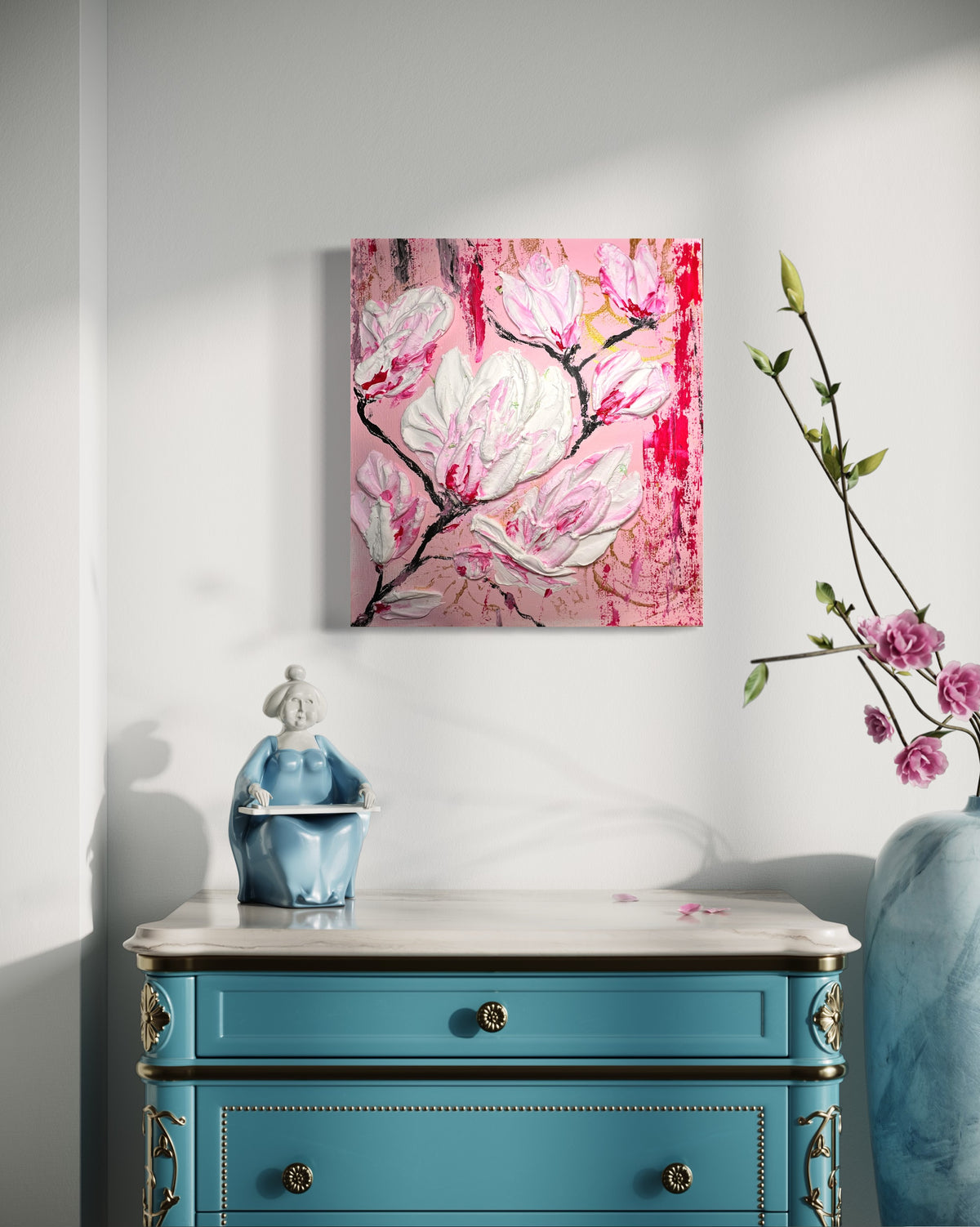 Pink and white magnolia-style floral wall art in a black frame