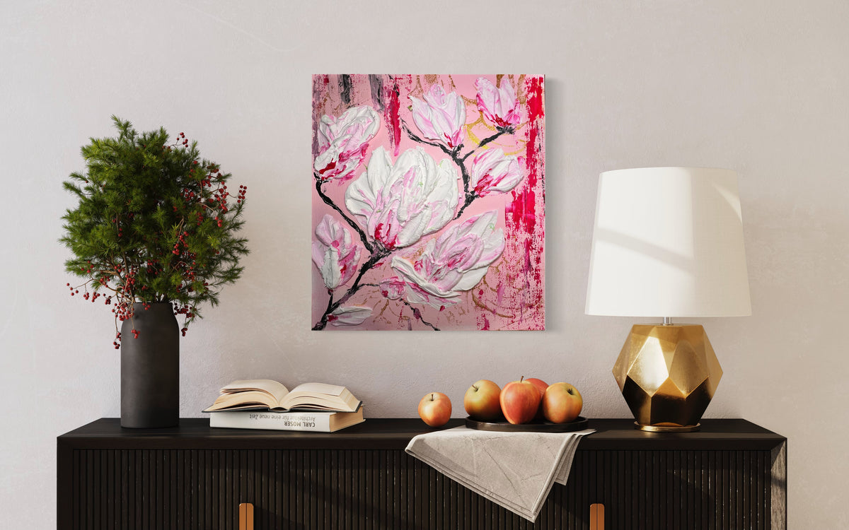 Floral wall art canvas with pink and white magnolia flowers, in a black frame