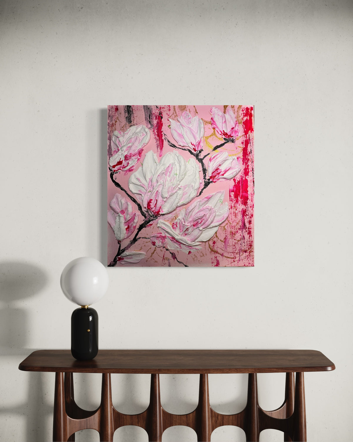 Pink and white magnolia floral wall art with a black frame