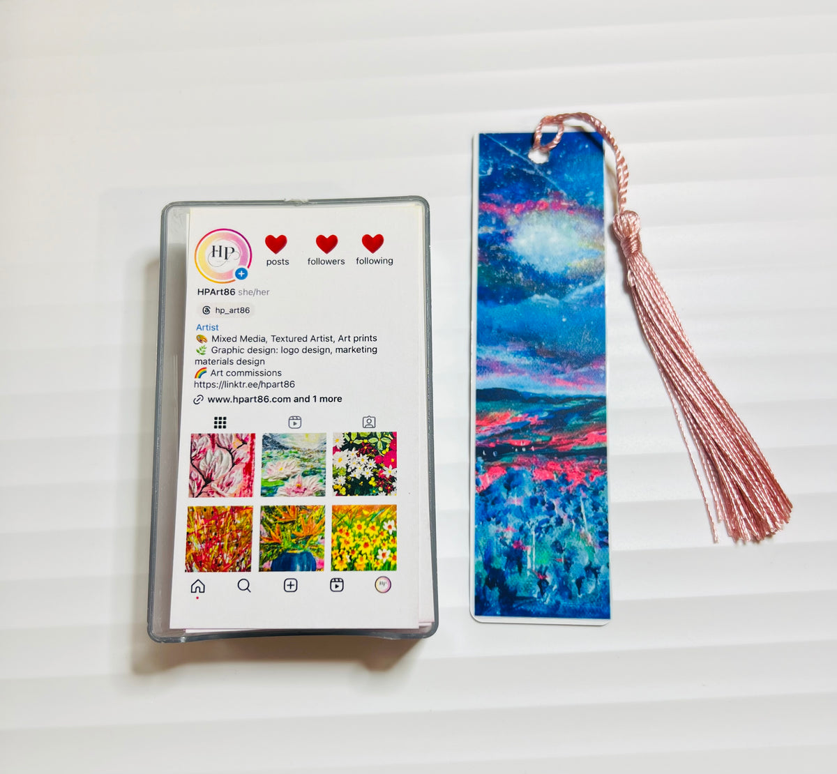 Metal bookmark with blue night-sky watercolor design and gold tassel