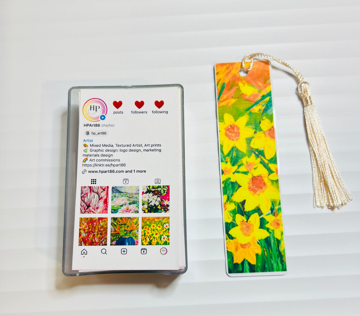 Metal bookmark with bright yellow flower artwork and gold tassel.