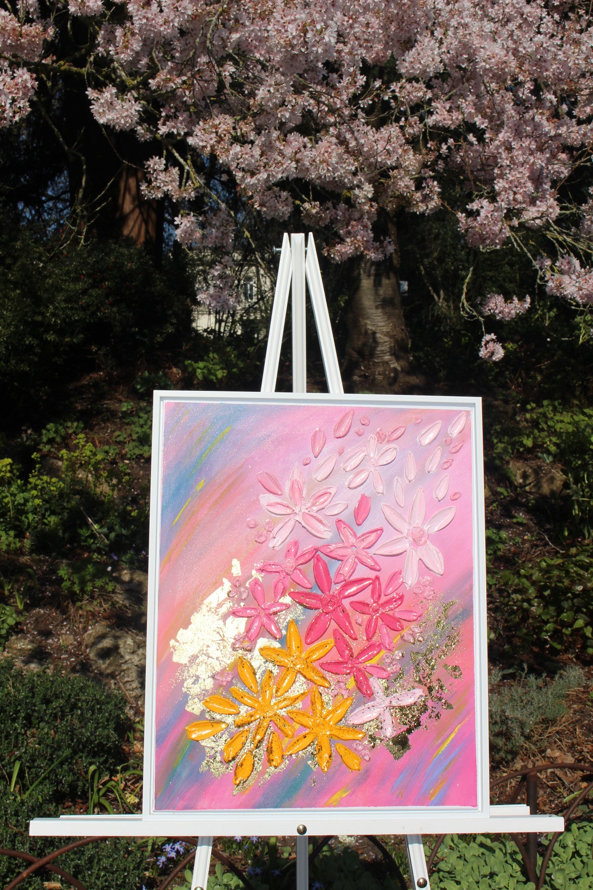 Framed floral wall art featuring pink and yellow jeweled flowers on a pastel canvas