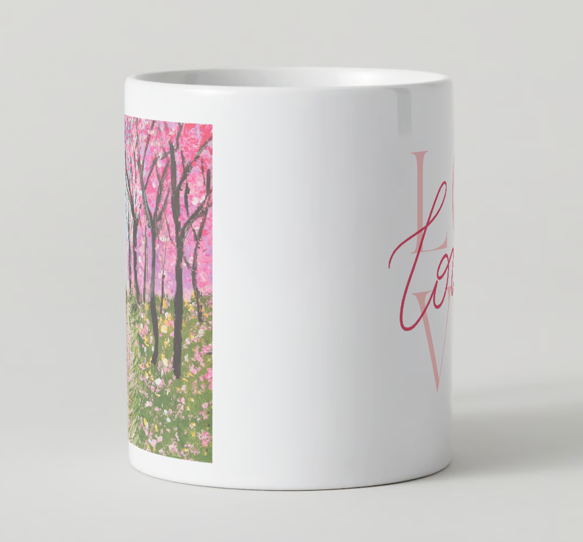 White ceramic mug showing side panel cherry blossom print and pink “Love” script