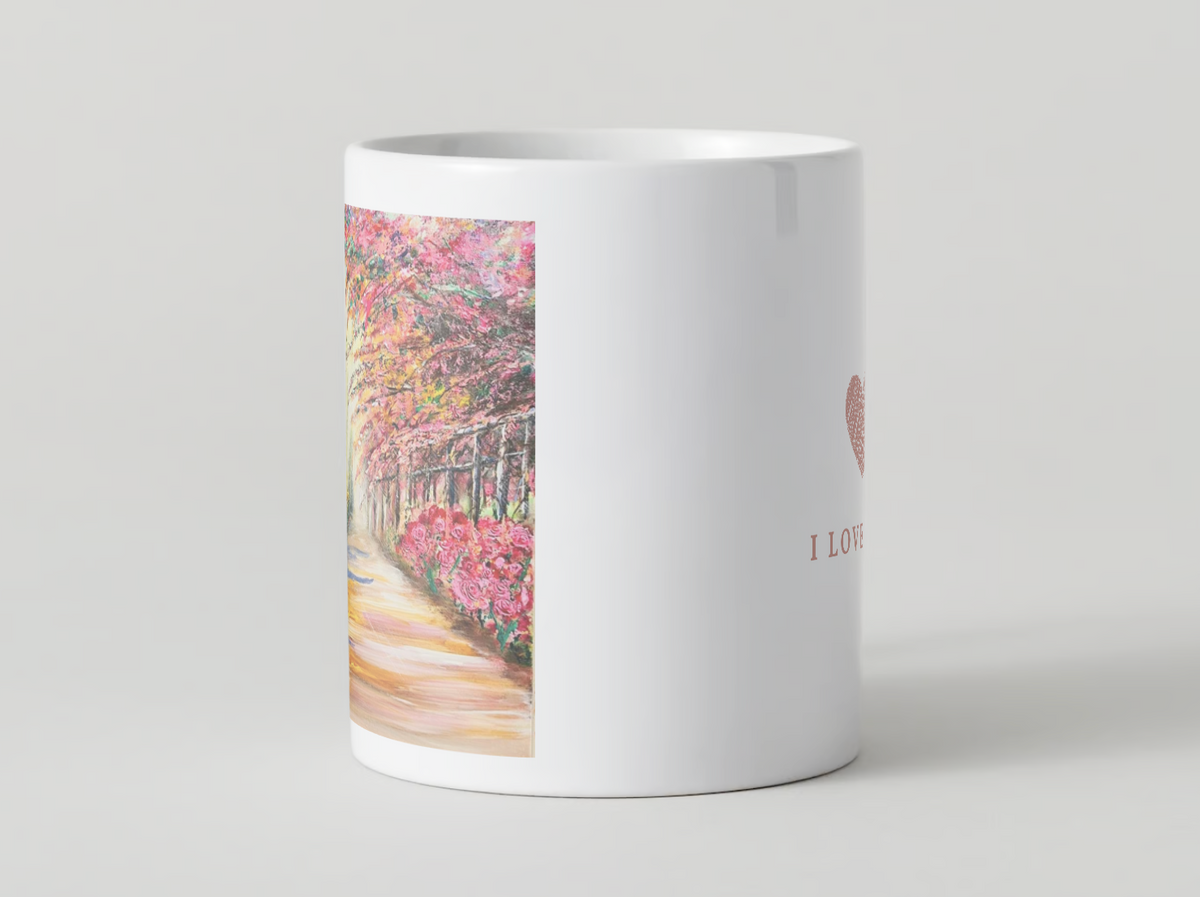 White ceramic mug showing full front print of a cherry blossom path scene