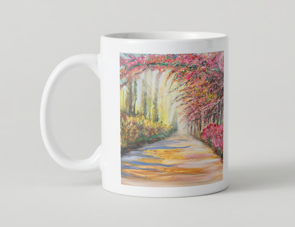 White ceramic mug with wide scenic path artwork and colorful spring trees