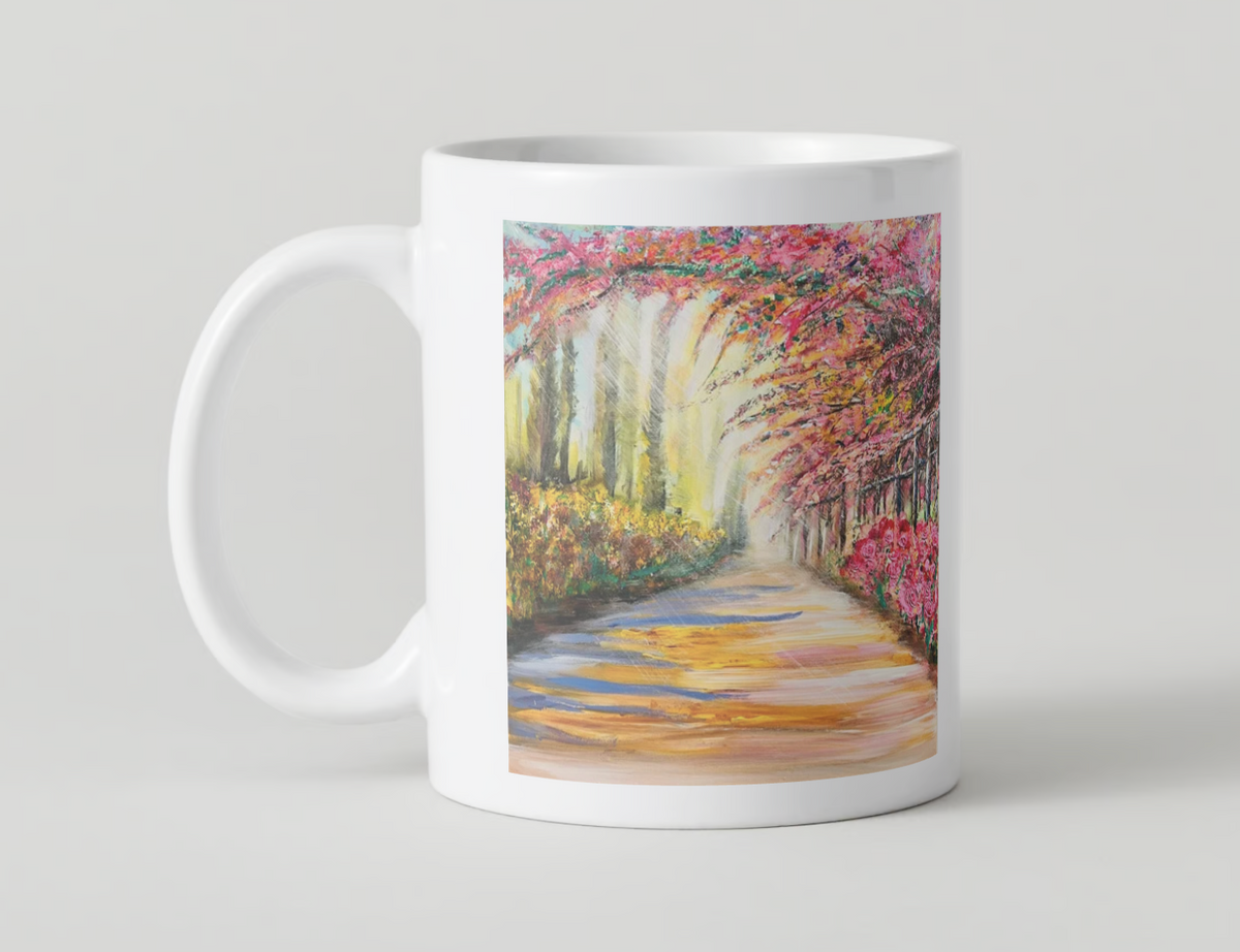 White ceramic mug with wide scenic path artwork and colorful spring trees