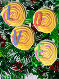 Round textured wooden letter baubles with raised swirl design and colorful letter shapes