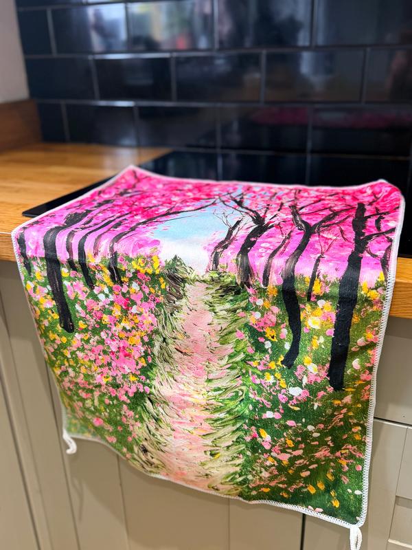 18x26-inch polyester kitchen towel featuring a vibrant pink cherry blossom forest painting with a floral path.