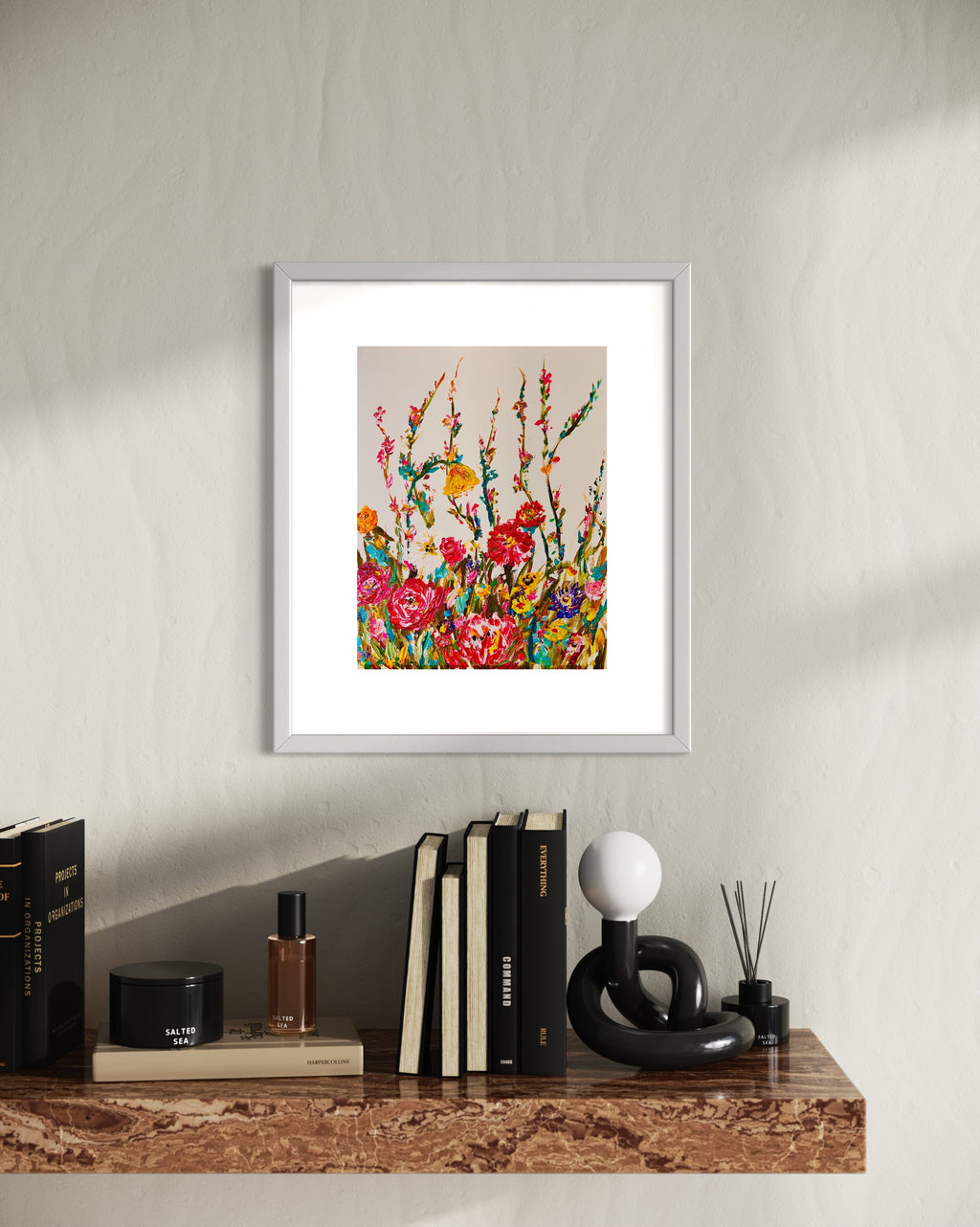 Framed floral wall art print with vivid blossoms and leafy stems in a light gray frame