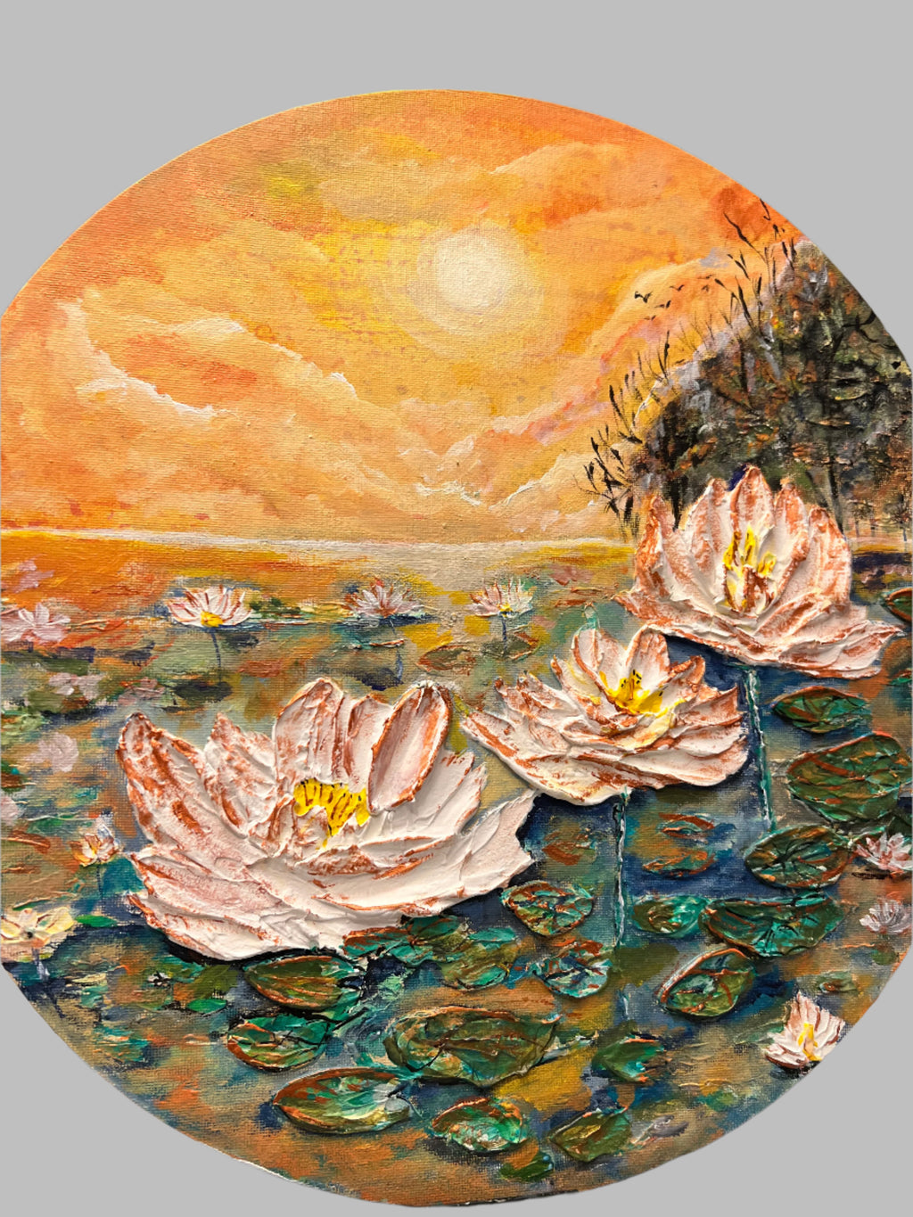 Round canvas wall art, close view of textured waterlily pond with white lilies and orange sky