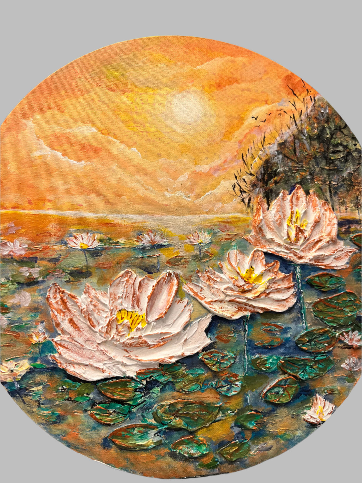 Round canvas wall art, close view of textured waterlily pond with white lilies and orange sky