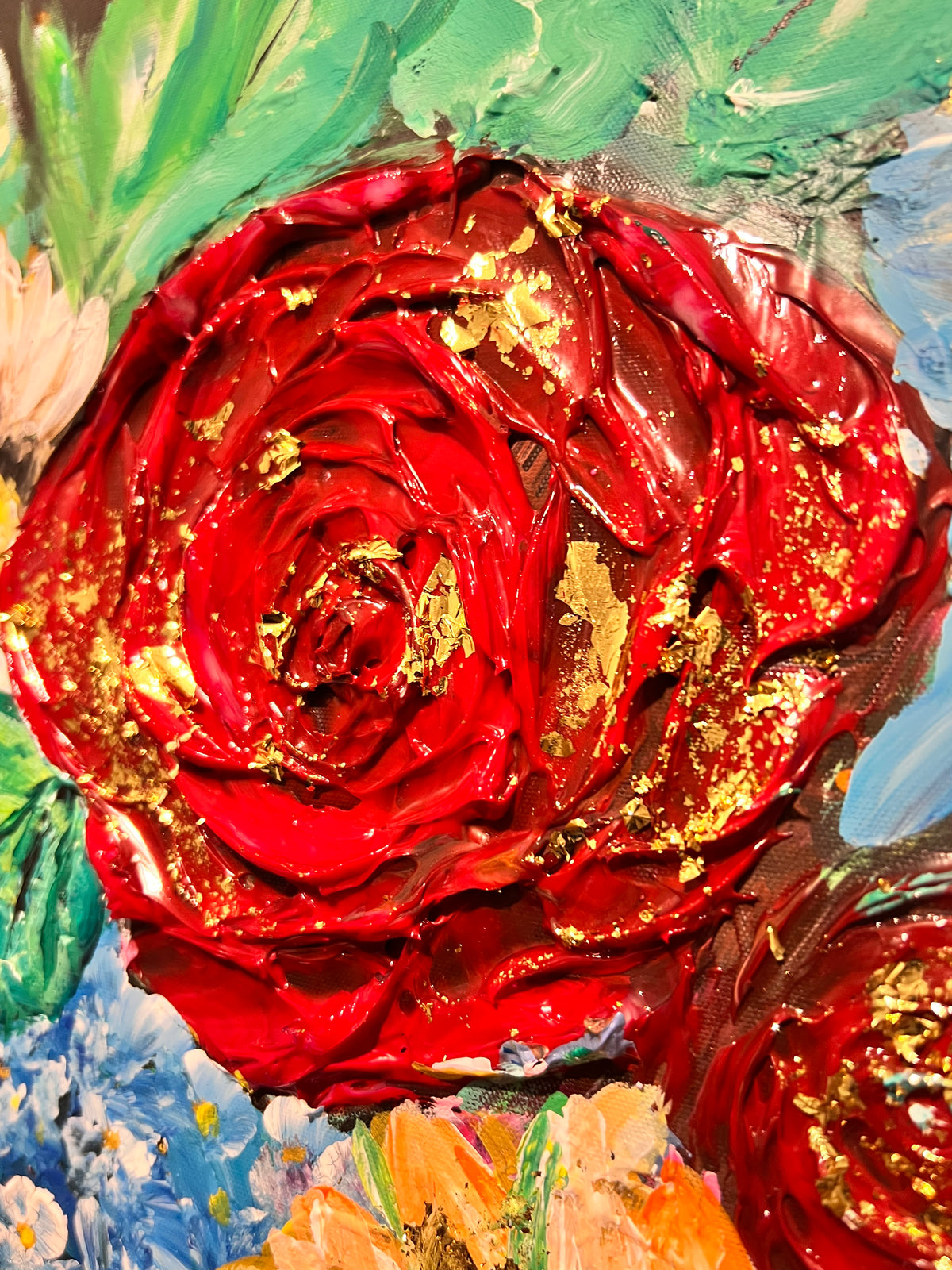Close-up of textured floral mixed media painting with glossy red rose and gold highlights