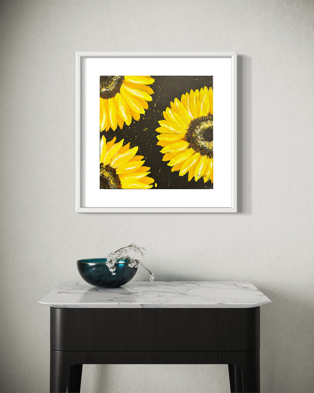 White-framed sunflower artwork with yellow blooms on dark speckled background.