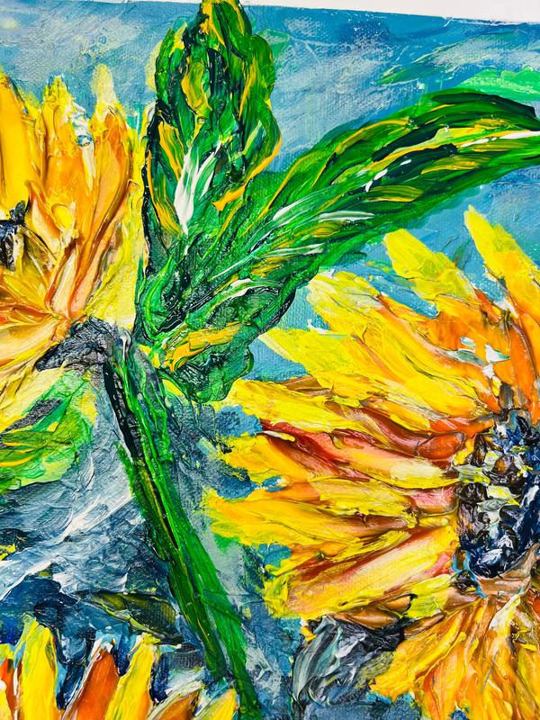 Framed sunflower painting with multiple yellow petals, deep green leaves, and blue background.