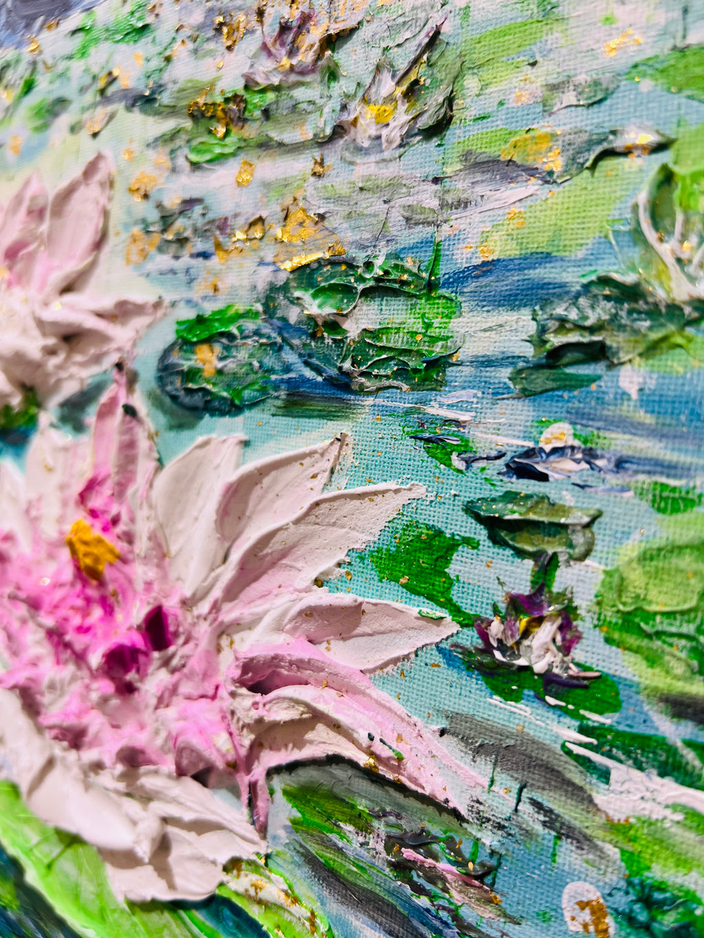 Textured close-up of pink and white waterlily blossoms with green lily pads on canvas