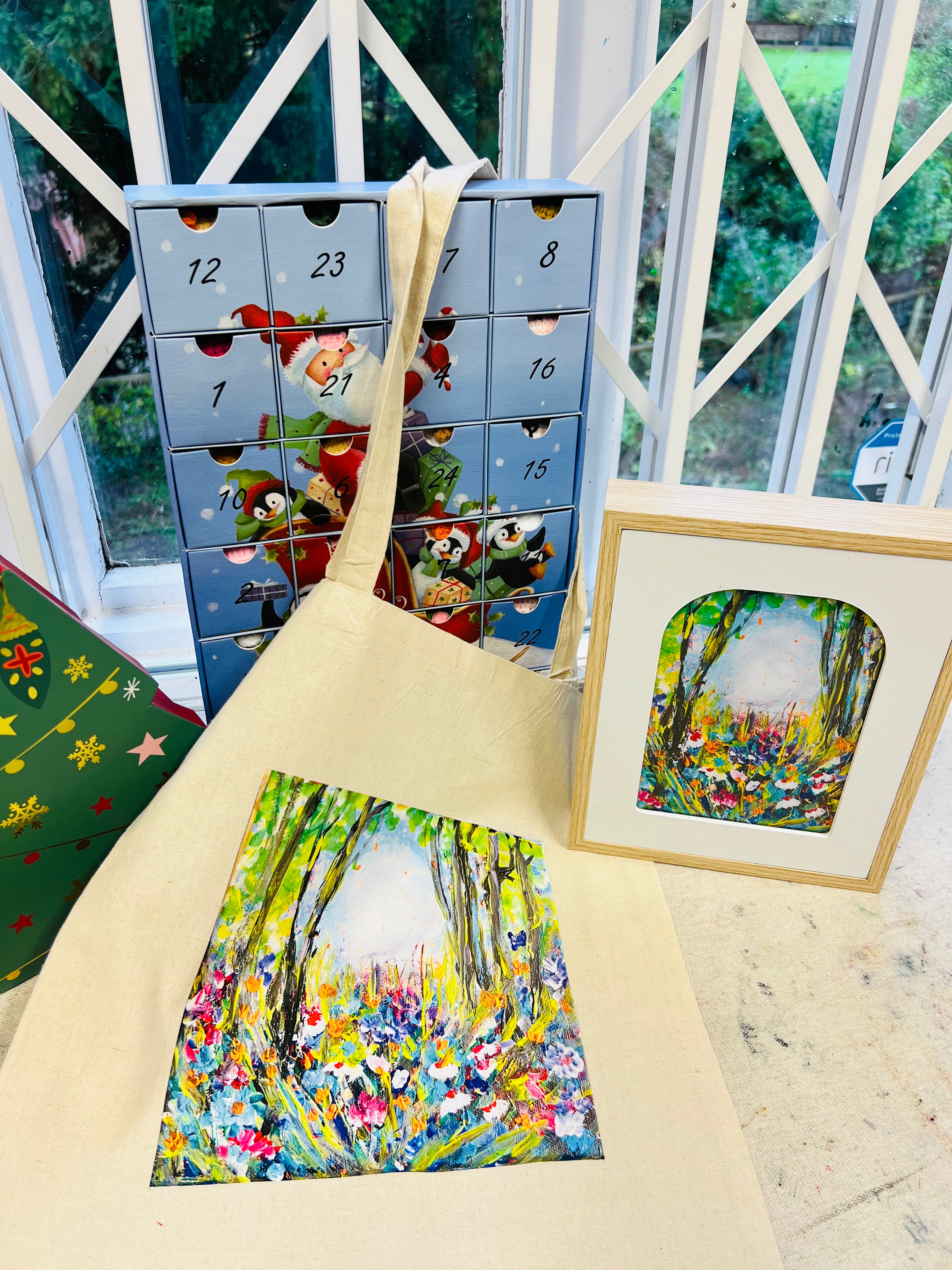 Symphony of Flowers gift set featuring a framed art print, a cotton canvas tote, and a card with vibrant floral forest art.