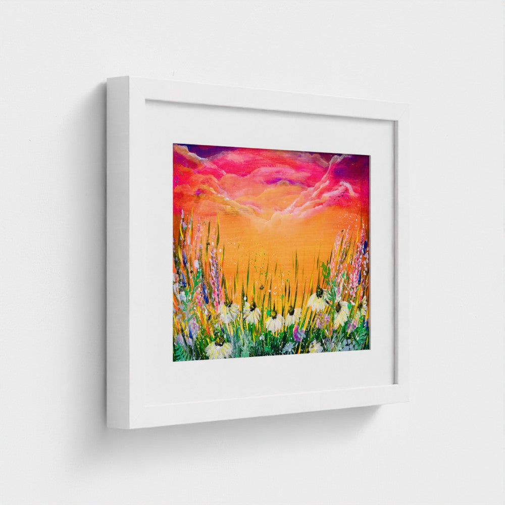 Framed art print with white frame, colorful sunset landscape with tall grass and flowers