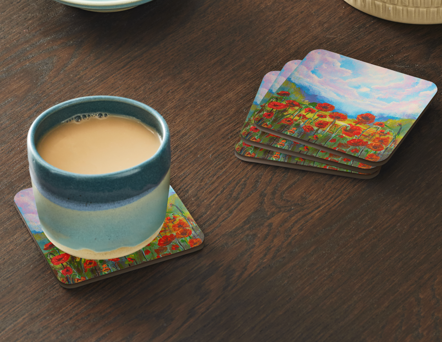 Set of four 9.5cm art coaster featuring a painted red poppy field with a golden meadow and dramatic pink and blue cloudscape