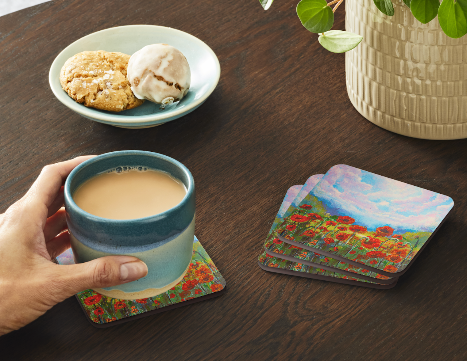 Set of four  9.5cm art coaster featuring a painted red poppy field with a golden meadow and dramatic pink and blue cloudscape