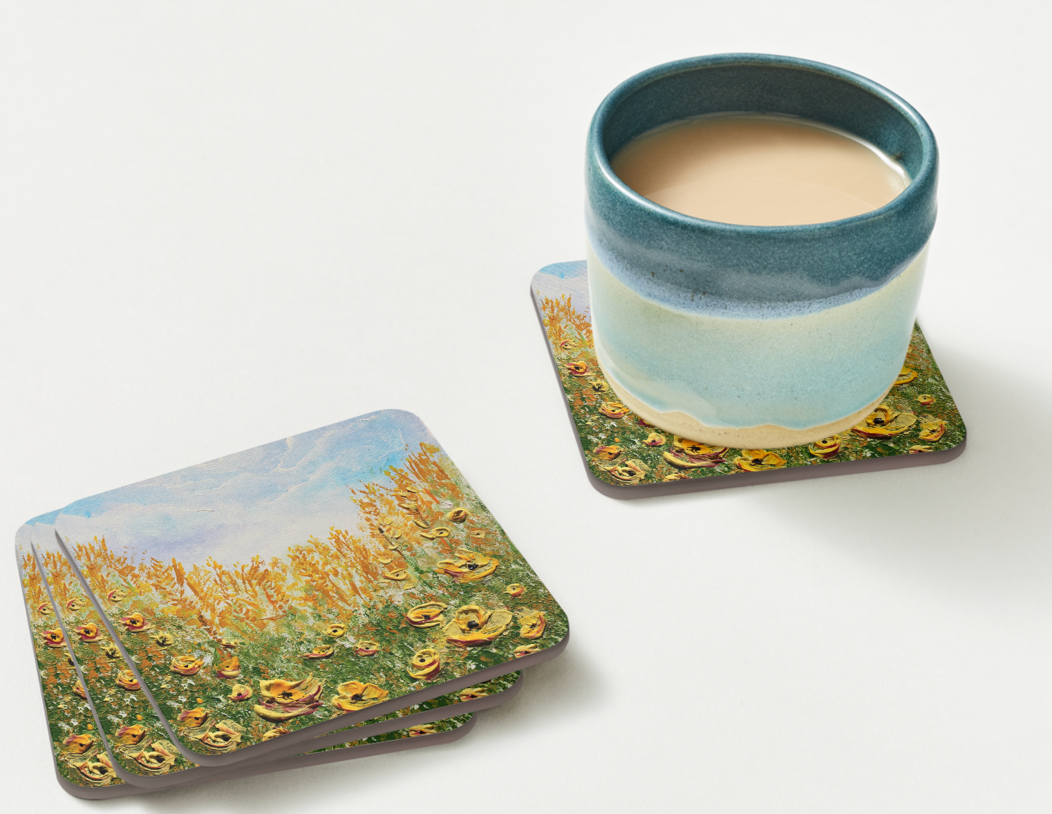 set of 4  9.5cm art coaster featuring a painted golden poppy field with amber grasses and a soft blue sky