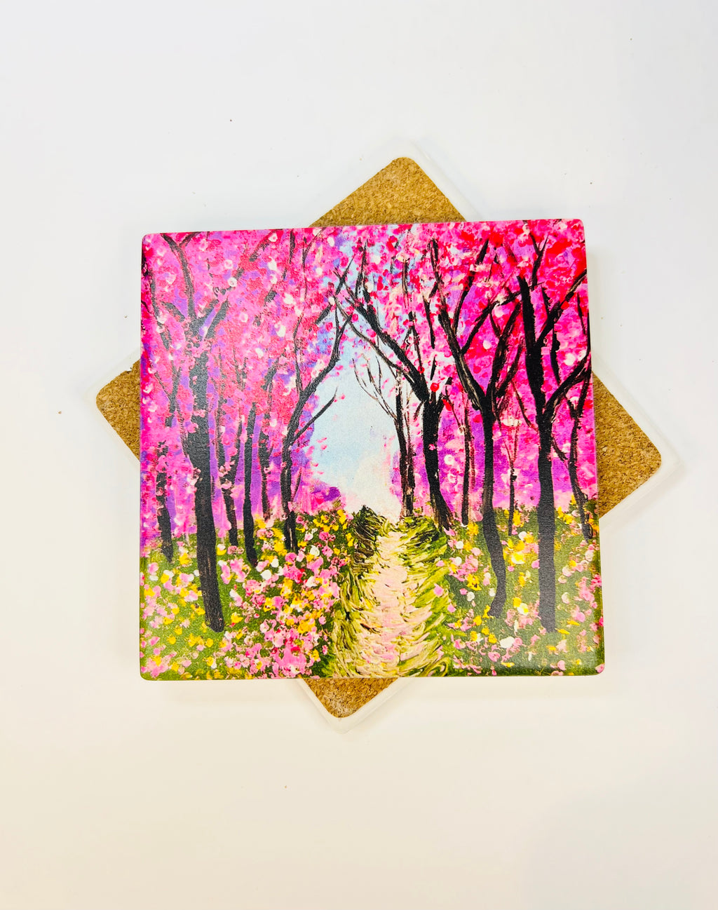 Square ceramic coaster with pink cherry blossom path artwork, gold decorative backing behind