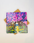 Square ceramic coaster with colorful cherry road landscape art print, cork backing visible