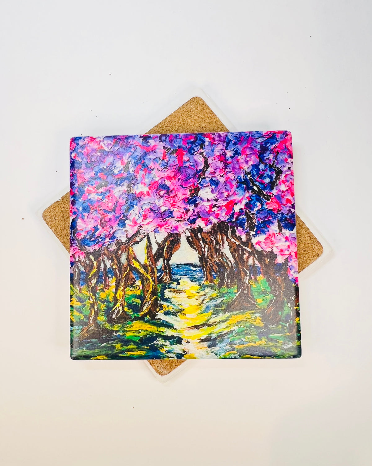 Square ceramic coaster with colorful cherry road landscape art print, cork backing visible