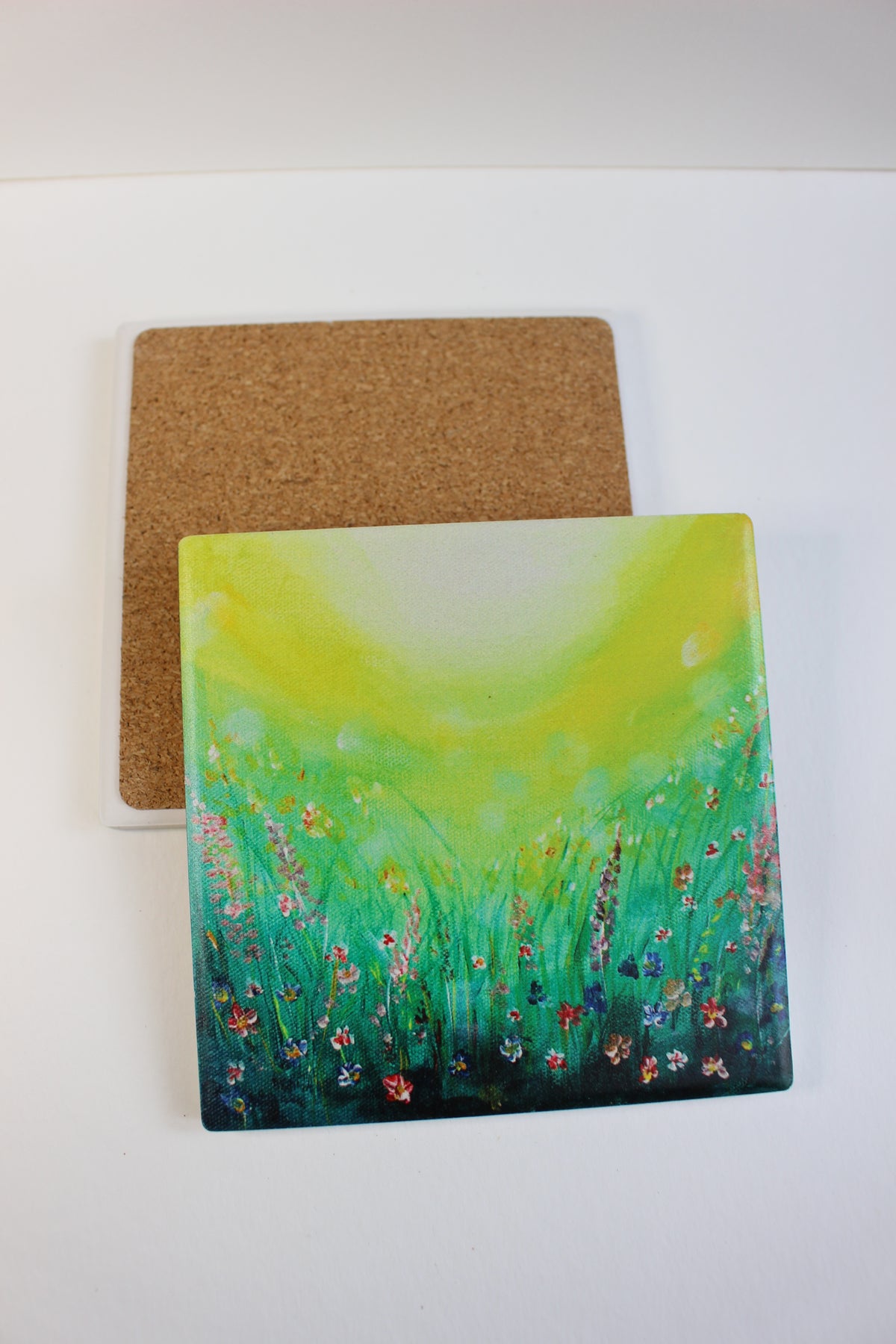 10x10cm square ceramic coaster with a vibrant green field art print and protective cork backing.