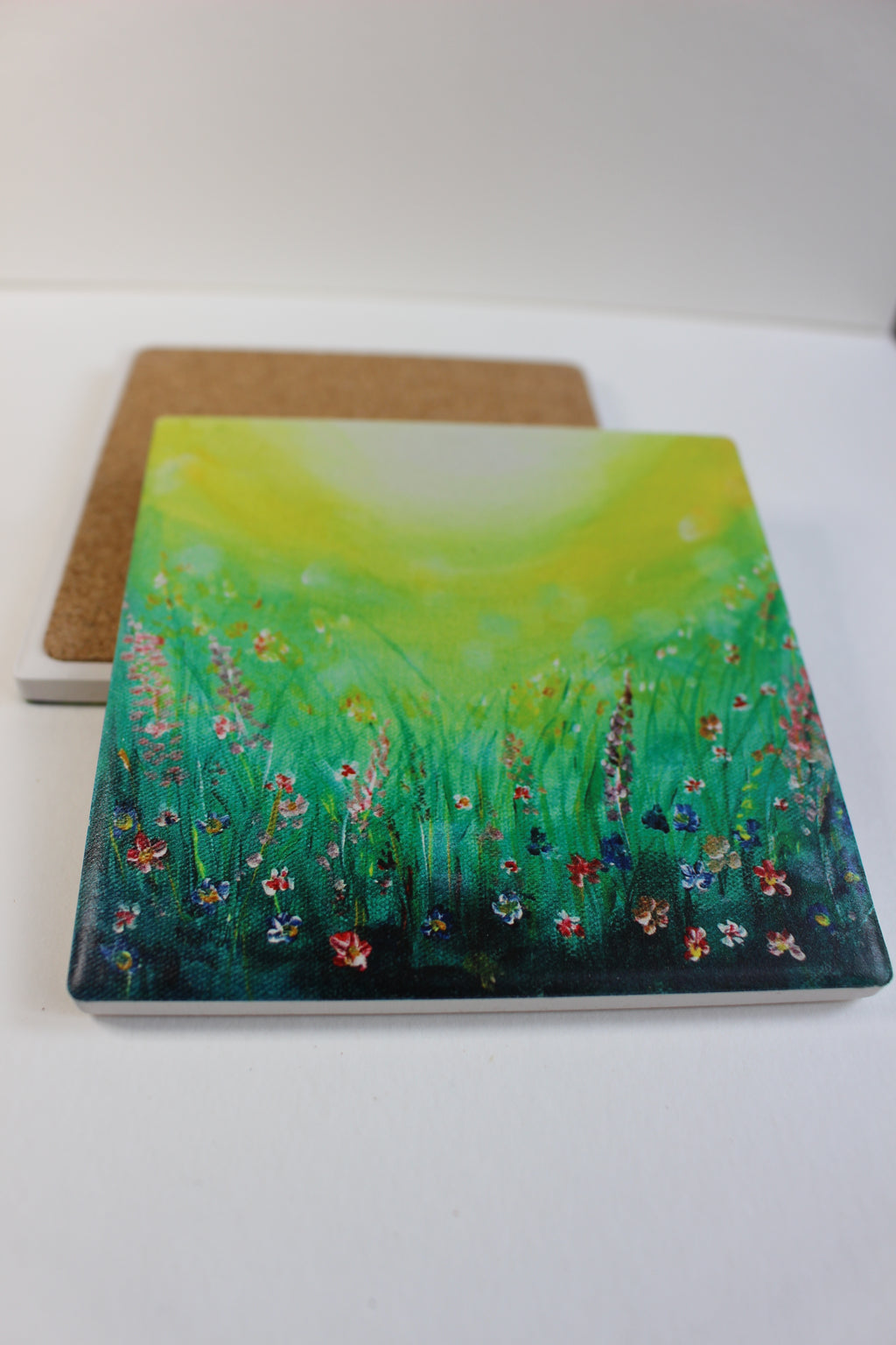 10x10cm square ceramic coaster featuring a vibrant green field art print with a protective cork backing.