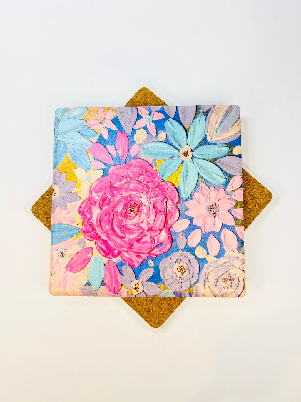 Square ceramic coaster with colorful floral design and pink rose, viewed from above