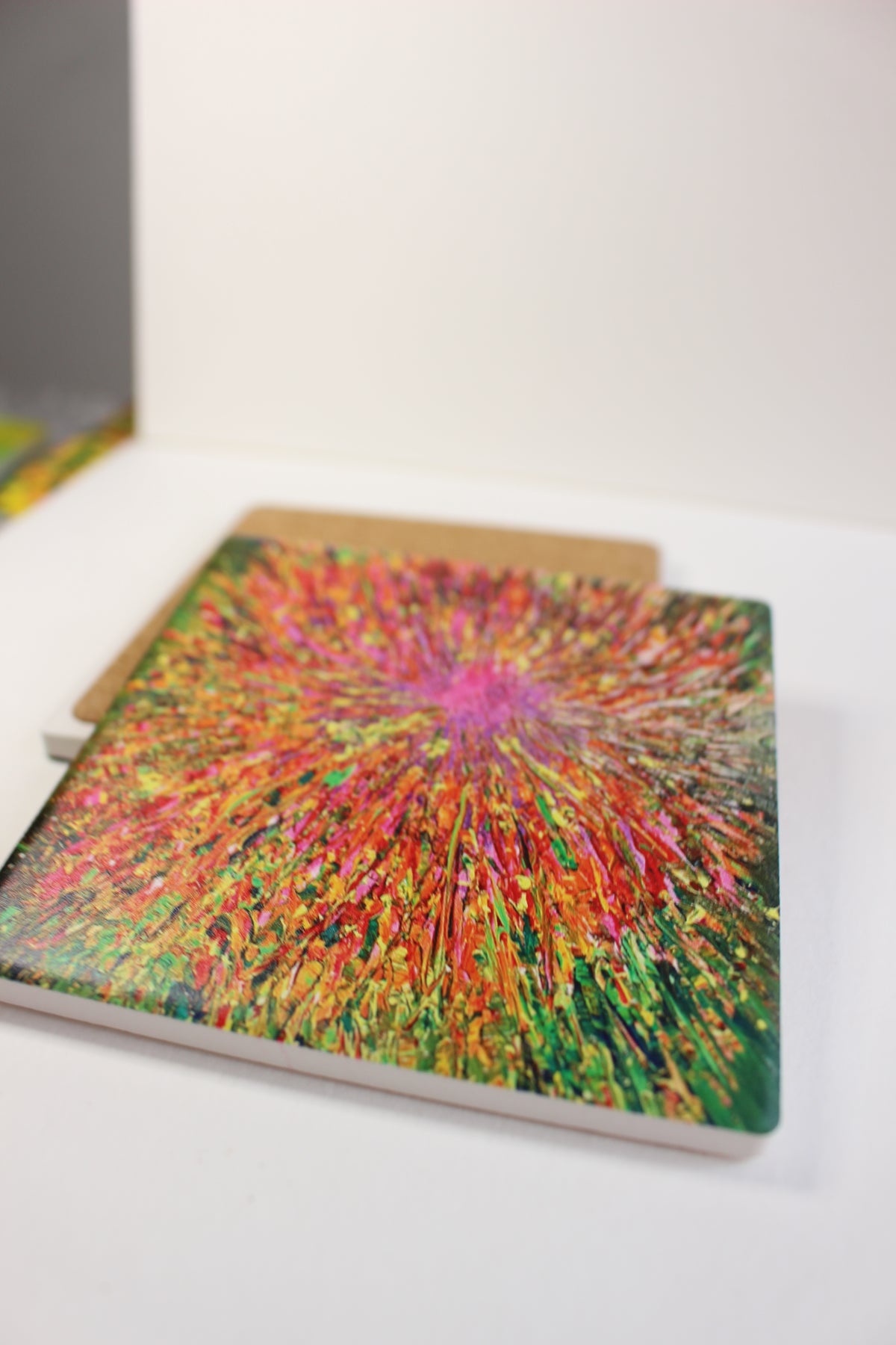 10x10cm square ceramic coaster featuring a vibrant, hand-painted abstract explosion of red, yellow, and green colors.