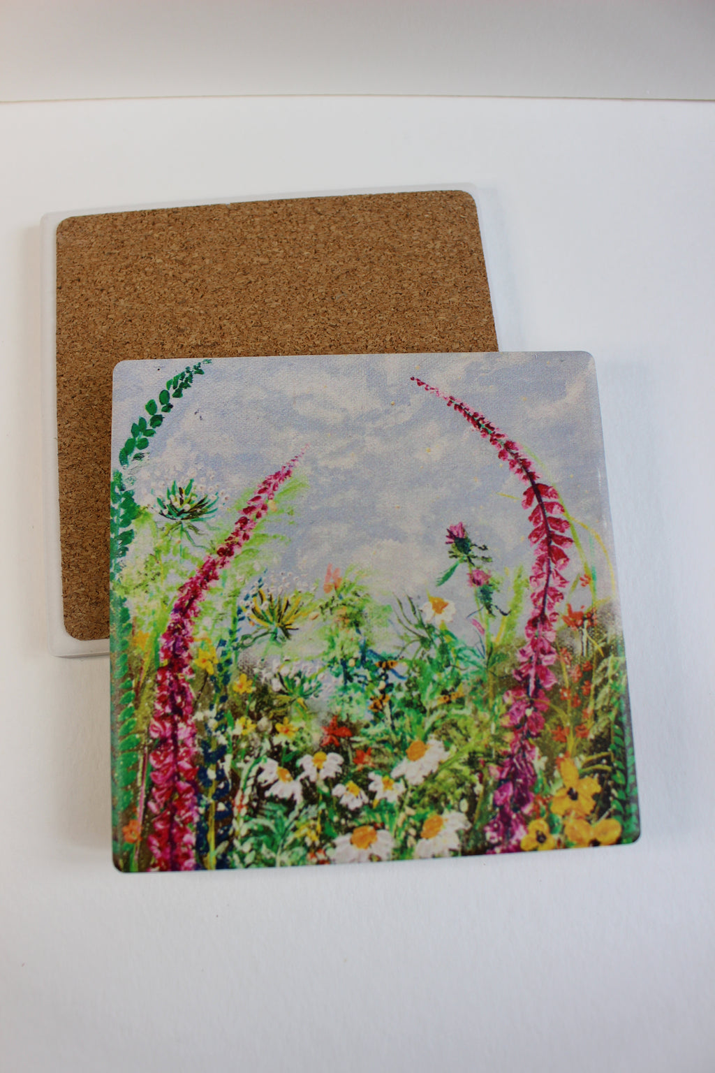 10x10cm square ceramic coaster featuring colorful hand-painted wild flowers with a protective cork backing.