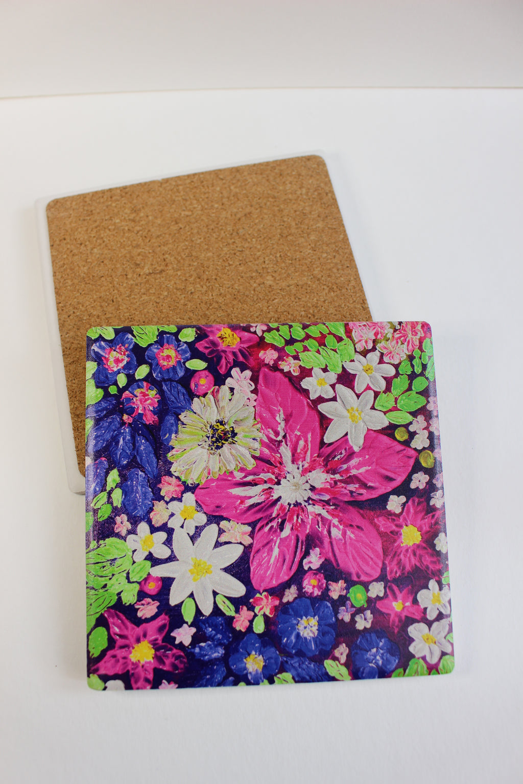 10x10cm square ceramic coaster with vibrant hand-painted floral art and a protective cork backing.